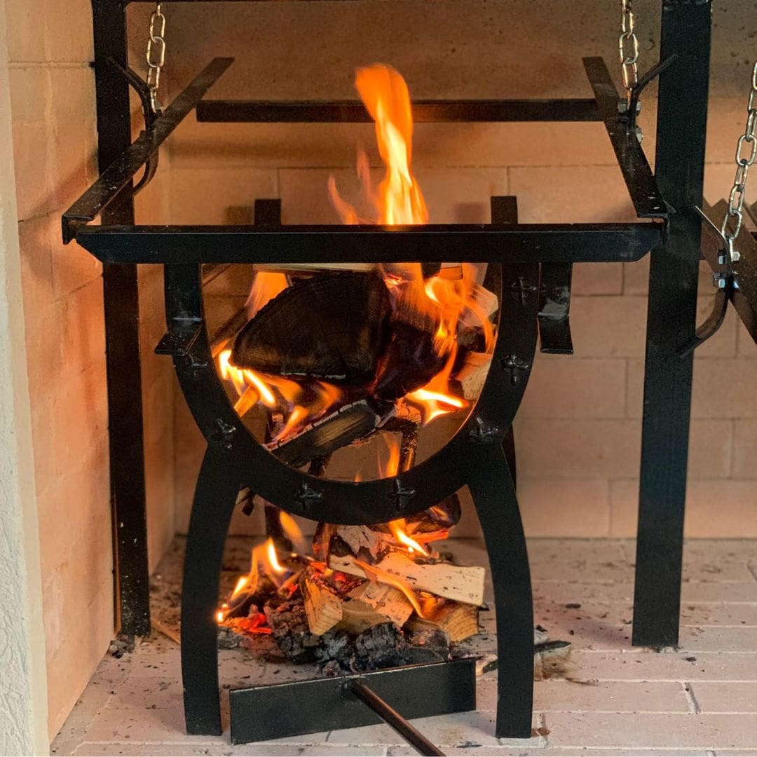 Close-up of a wood fire burning inside an Argentinian barbecue grill.